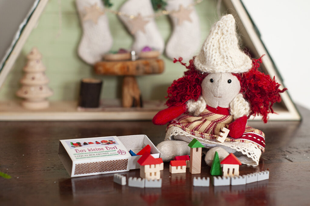Christmas elf with miniature christmas town blocks