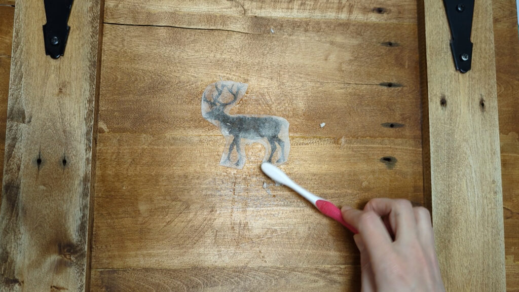 removing paper backing with toothbrush